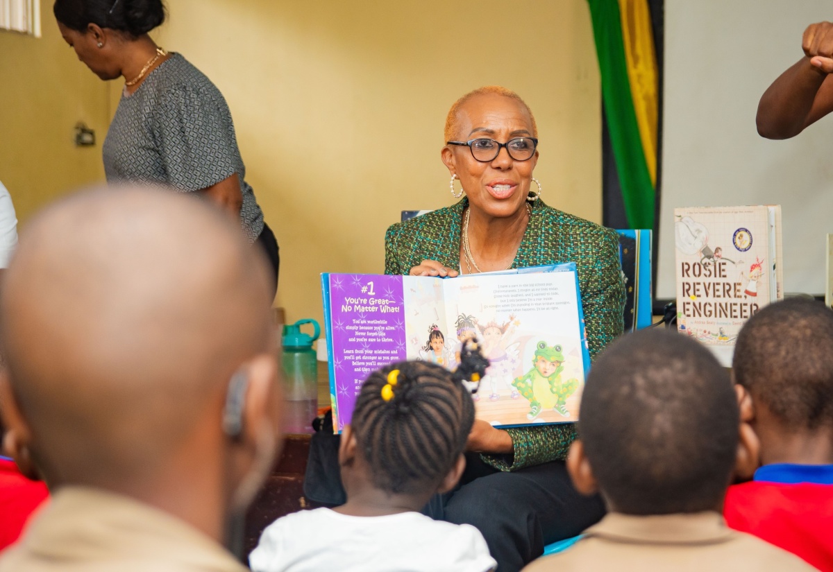 Minister of Education and Youth, Hon. Fayval Williams, has the attention of students from the Danny Williams School for the Deaf during Read Across Jamaica Day activities at the institution in Kingston. The day was observed on May 7.

