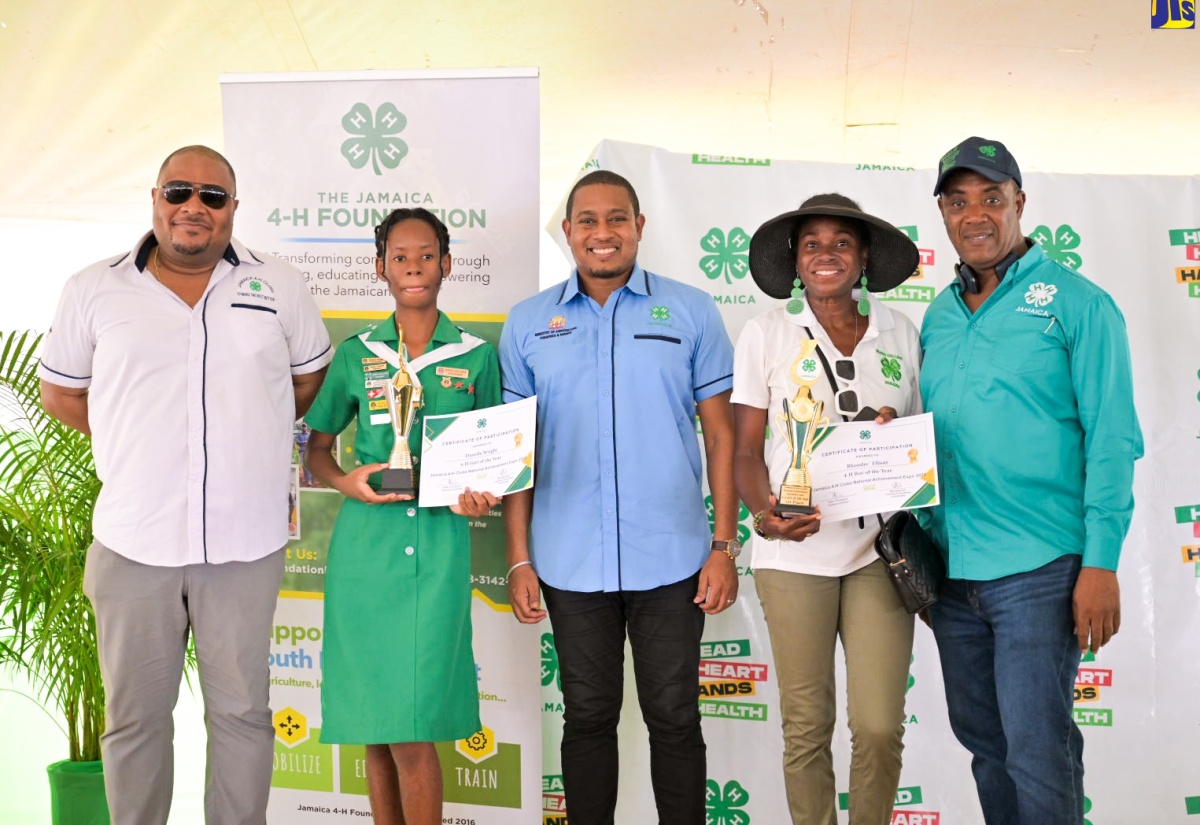Minister of Agriculture, Fisheries and Mining, Hon. Floyd Green (centre), celebrates with Jamaica 4-H Clubs Girl of the Year, Deneila Wright (second left), at the 4-H National Achievement Expo, held at the Denbigh 4-H Centre, in Clarendon on May 10. Others (from left) are Chairman of the 4-H Clubs, Collin Virgo; Tricia Elliot, mother of Rhondre Elliot, who was crowned the 4-H Boy of the Year and Executive Director of the organisation, Peter Thompson.