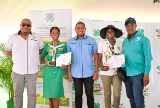 Minister of Agriculture, Fisheries and Mining, Hon. Floyd Green (centre), celebrates with Jamaica 4-H Clubs Girl of the Year, Deneila Wright (second left), at the 4-H National Achievement Expo, held at the Denbigh 4-H Centre, in Clarendon on May 10. Others (from left) are Chairman of the 4-H Clubs, Collin Virgo; Tricia Elliot, mother of Rhondre Elliot, who was crowned the 4-H Boy of the Year and Executive Director of the organisation, Peter Thompson.