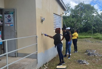 Contestants of this year’s Westmoreland Festival Queen Competition paint a section of the Cornwall Mountain Health Centre in Westmoreland during Labour Day activities at the facility on (Thursday) May 23.
