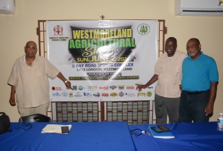 Chairman of the Planning Committee of the Westmoreland Agricultural Show 2024, Pius Lacan (left); Health Promotion and Education Officer for Westmoreland, Gerald Miller (centre); and First Vice President of the Westmoreland Association of Branch Societies of the Jamaica Agricultural Society (JAS), Ian Hill; show off the banner for the Westmoreland Agricultural Show 2024 to be held at Bay Road Sports Complex, in Little London, on Sunday, June 2.

