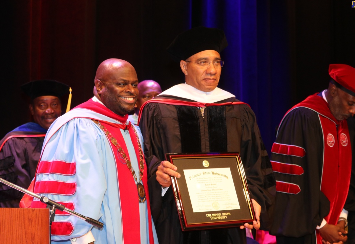Prime Minister the Most Hon. Andrew Holness (right) displays his honorary degree of Doctor of Humane Letters following its presentation by the President of Delaware State University, Dr. Tony Allen at the university’s 2024 commencement ceremony held on Friday (May 10) in Dover, Delaware.

