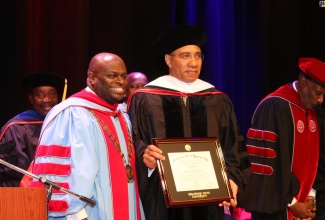 Prime Minister the Most Hon. Andrew Holness (right) displays his honorary degree of Doctor of Humane Letters following its presentation by the President of Delaware State University, Dr. Tony Allen at the university’s 2024 commencement ceremony held on Friday (May 10) in Dover, Delaware.

