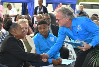 Minister of Culture, Gender, Entertainment and Sport, Hon. Olivia Grange (left), is greeted by Chairman of R.A.Williams Distributors Limited, John Bailey (right), at the opening of the new R.A. Williams Warehouse in New Brunswick Village, Spanish Town, St. Catherine, on May 1. Also pictured are European Union Ambassador to Jamaica, Her Excellency Marianne Van Steen,  and Chief Executive Officer, R. A. Williams Distributors Limited, Audley Reid.

