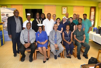 Consultant Ophthalmologist, Mandeville Regional Hospital, Dr. Gavin Henry (seated, left), with members of the visiting team who performed 627 eye surgeries at the Manchester-based institution from May 25 to 27, and representatives from the Southern Regional Health Authority. Also seated (from second left) are: Matron Sadie Allen; Cataract Camp team leader, Dr. Nitin Shah; Chairman, Mind, Body and Soul Health Ministry, Hilary Morgan, and Eye Surgeon, Dr. Vipaul Prajapati.
