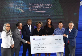 The Jamaica Productivity Centre (JPC) in the Ministry of Labour and Social Security, is presented with a $1 million donation by the Development Bank of Jamaica (DBJ), as a contribution towards the JPC’s various projects to promote productivity. Acting Managing Director, DBJ, David Wan (right), handed over the cheque during the media launch of the Ministry’s Future of Work and Productivity Summit held on May 9 at the University of Technology (UTech) campus in St. Andrew. Accepting the contribution are Permanent Secretary in the Ministry, Colette Roberts Risden (left); State Minister, Dr. the Hon. Norman Dunn (second left); portfolio Minister, Hon. Pearnel Charles Jr (third left); Chief Technical Director, JPC, Tamar Nelson (third right); and JPC Board Chairman, Omar Azan (second right). Sharing the moment is Minister without Portfolio in the Office of the Prime Minister with responsibility for Skills and Digital Transformation, Dr. the Hon. Dana Morris Dixon (centre).

