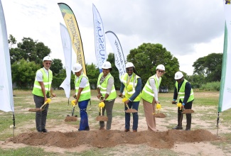 State Minister for Foreign Affairs and Foreign Trade, and Member of Parliament for St. Catherine East Central, Hon. Alando Terrelonge (third right), participates in the breaking of ground for the construction of a multipurpose court at the Gregory Park Primary School in St. Catherine on Wednesday (May 29). Joining him are (from left) Sports Development Foundation General Manager, Alan Beckford; Director of the Toll Authority, Patrick Rose; Executive Director of the National Education Trust (NET), Latoya Harris Ghartey; Chairman of Musson Foundation, Melanie Subratie; and Principal of Gregory Park High School, Richard Williams.

