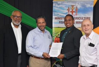 Minister of Agriculture, Fisheries and Mining, Hon. Floyd Green (second right) and Managing Director, Jamaica Flour Mills, Derrick Nembhard (second left), display the signed Memorandum of Understanding (MOU) among the Sugar Company of Jamaica Holdings Limited (SCJ), Jamaica Flour Mills and the University of the West Indies/SODECO. Under the MOU, the SCJ will lease 725 acres of land in Clarendon to Jamaica Flour Mills and UWI/SODECO for the purposes of cultivating breadfruit, roots and tubers that will be used by the Jamaica Flour Mills to produce gluten-free flour. Sharing the occasion are (from left) Chief Scientist, University of the West Indies/SODECO, Professor Terrence Forrester; and Chief Executive Officer, Sugar Company of Jamaica Holdings, Joseph Shoucair. The signing took place at the Ministry of Agriculture, Fisheries and Mining,  in St. Andrew, on April 25.

