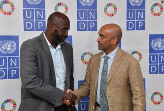 Acting Director General for the Office of Disaster Preparedness and Emergency Management (ODPEM), Richard Thompson (left), greets United Nations Development Programme (UNDP) Resident Representative, Kishan Khoday, during Friday’s (May 17) UNDP Disaster Risk Resilience Knowledge Exchange. The session was held at the UNDP’s Lady Musgrave Road offices in Kingston. 