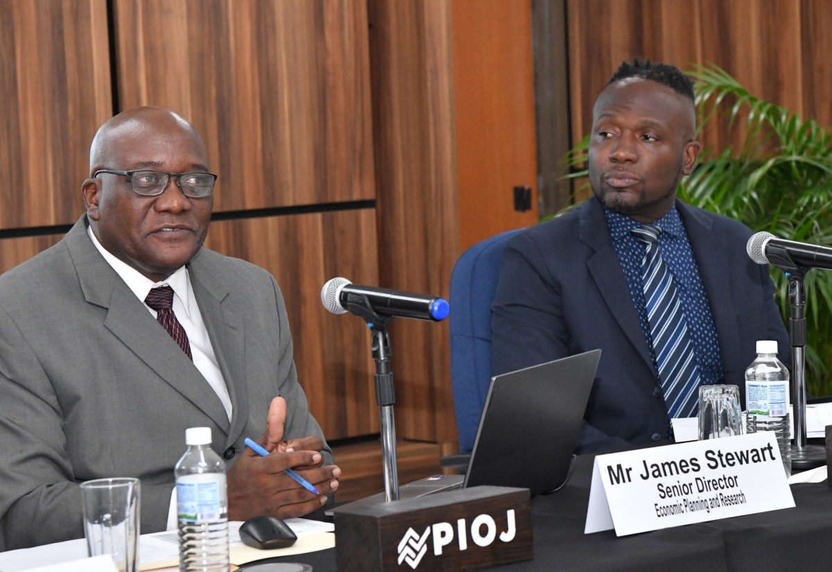 Planning Institute of Jamaica (PIOJ) Senior Director in the Economic Planning and Research Division, James Stewart (left), addresses Tuesday’s (May 28) PIOJ quarterly briefing. With him is PIOJ Director of Modelling and Research, Hugh Morris. 