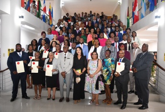 Custos Rotulorum for St. Andrew, Hon. Ian Forbes (fourth left, front row), shares a photo opportunity with the 112 newly commissioned Justices of the Peace for the parish. They were sworn into office during a ceremony at the Caribbean Military Academy Auditorium, Jamaica Defence Force (JDF) Headquarters, Up Park Camp, Kingston, on Saturday (May 18).

