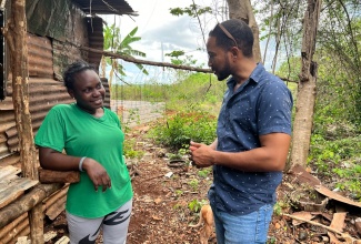 Livestock Specialist with the 'Improving Rural Livelihoods through Resilient Agrifood Systems’ Project of the FAO, Cabrini Edwards, in dialogue with one of the beneficiaries of the project, Roxanne Robinson, in Kitson Town, St. Catherine.