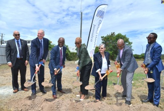 Minister of Education and Youth, Hon. Faval Williams (centre), participates in the ground-breaking for the construction of a high school at Christel House, Twickenham Park in St. Catherine, today (May 1). Also taking part (from left) are Country Representative for the United States Agency for International Development (USAID), Dr. Jaidev Singh; President and Chief Executive Officer of Christel House International, Bart Peterson; Chairman of Christel House Jamaica, Hon. Steadman Fuller, Co-Founder and National Ambassador for Christel House Jamaica, Sally Porteous; Mayor of Spanish Town, Councillor Norman Scott, and Principal of the school, Jason Scott.


