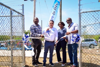 Minister without Portfolio in the Ministry of Economic Growth and Job Creation, Senator the Hon. Matthew Samuda (second left), cuts the ribbon to officially commission the Hellshire Phase 3 Booster Pump Station, today May 17. Sharing the moment (from left) are Regional Manager at the National Water Commission (NWC), Gawaine Johnson; Director at the Ministry, Janet Coleman Howlett, and Member of Parliament for St. Catherine Southern, Fitz Jackson.

