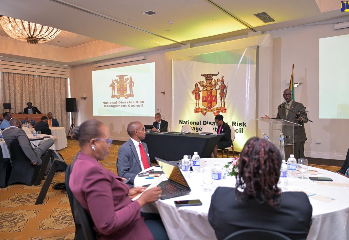 Minister of Local Government and Community Development, Hon. Desmond McKenzie (at lectern), addresses the National Disaster Risk Management Council meeting at Sandals Ochi Beach Resort in St. Ann on Wednesday (May 29). 