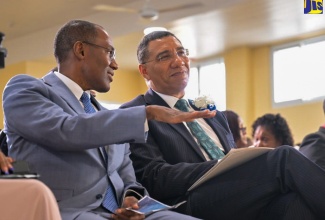 Prime Minister, the Most Hon. Andrew Holness (right), listens to a point being made by Minister of Finance and the Public Service, Dr. the Hon. Nigel Clarke, during the Jamaica Civil Service Association’s 105th annual general meeting at Jacisera Park in St. Andrew on May 30.