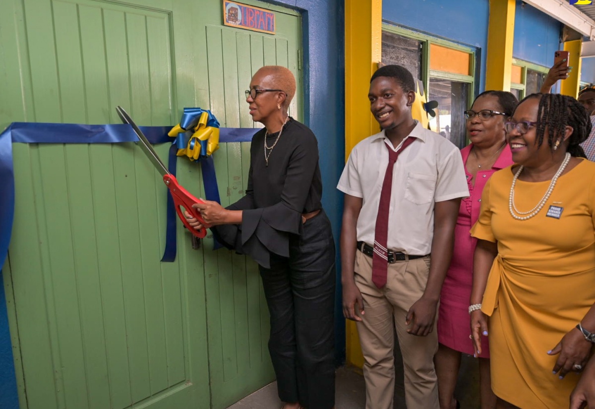 Minister of Education and Youth, Hon. Fayval Williams (left), formally opens a room at the Randolph Lopez School of Hope in St. Andrew, which was outfitted with computers donated by the Kiwanis Club of New Kingston. The room was officially opened during a brief handover ceremony on Tuesday (May 14). Sharing the moment are (from second left) student at the school and President of the Aktion Club, Anthony Lopez; Major Projects Chair, Kiwanis Club of New Kingston, Pat Garel, and the Club’s Distinguished President for 2022-23, Professor Aldrie Henry-Lee.

