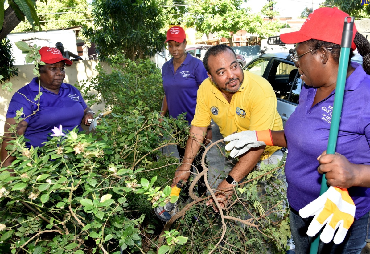 2023/24 Civil Servant of the year in the Managerial category, Opal Bryan (right), engages with President of the North St. Andrew Kiwanis Club, Jason McIntosh, during a Labour Day project at Reddies Place of Safety in Kingston on May 23. Looking on are Civil Servants of the Year in the Technical Support and Mid-Managerial categories respectively, Christine Rowe (left) and Ruth McGrowder. The Labour Day activity included repairs to sections of the Reddies Place of Safety, painting and general cleaning and beautification.