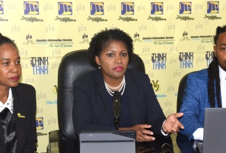 Executive Director, National Education Trust (NET), Latoya Harris Ghartey (centre), addresses a Jamaica Information Service (JIS) ‘Think Tank’ at the agency’s head office in Kingston on Tuesday (May 28). Listening (from left) are: Net Directors in charge of Donor and Partnership Management, Keisha Johnson, and Infrastructure Management, Christopher Wilson.