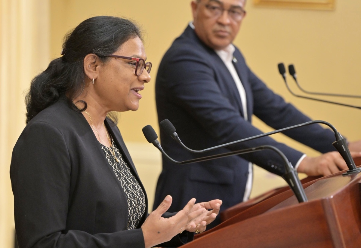 Minister of Health and Wellness, Dr. the Hon. Christopher Tufton, listens as Chief Medical Officer, Dr. Jacquiline Bisasor-McKenzie, addresses Wednesday’s (May 15) post-Cabinet press briefing at Jamaica House. 