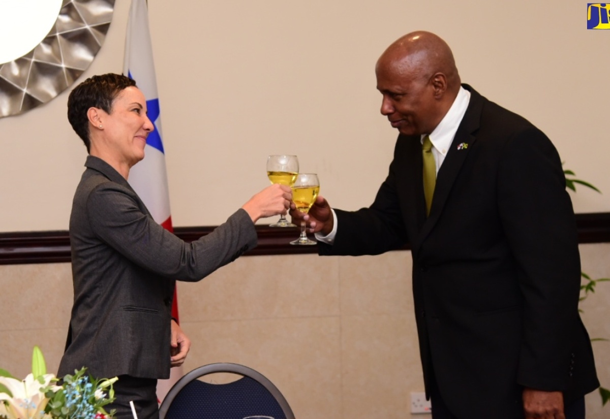 Minister of Foreign Affairs and Foreign Trade, Senator the Hon. Kamina Johnson Smith (left) and Ambassador of the Republic of Panama to Jamaica and Dean of the Diplomatic Corps, His Excellency Lasford Douglas, raise a toast during a farewell diplomatic lunch held on June 21 at the Jamaica Pegasus Hotel in New Kingston.