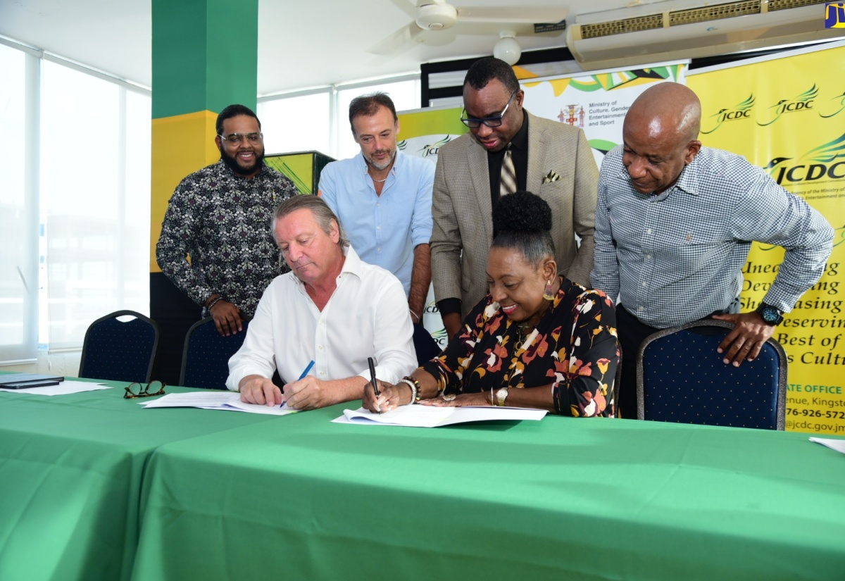 Culture, Gender, Entertainment and Sport Minister, Hon. Olivia Grange (right) and Managing Director of J. Wray & Nephew Limited, Jean-Phillippe Beyer, sign an agreement for $20 million in sponsorship support for Emancipation/Independence celebrations. The signing ceremony was held on Wednesday, June 12, at the Ministry’s New Kingston offices. Witnessing are (from left) Communications Manager, J. Wray & Nephew, Dominic Bell; Marketing Manager, Stefano Furini; Permanent Secretary in the Ministry of Culture, Gender, Entertainment and Sport, Deanroy Bernard; and Chief Executive Officer, Jamaica Cultural Development Commission (JCDC), Lenford Salmon. 