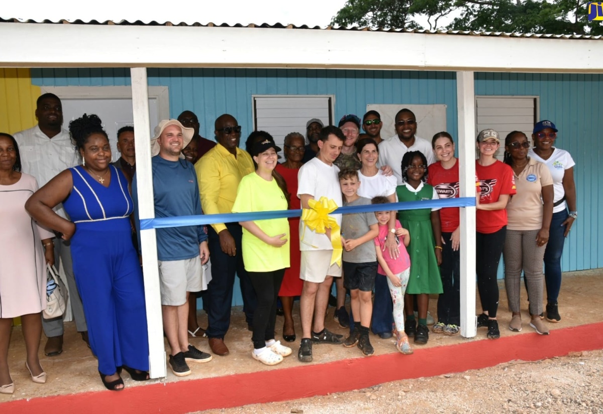 Minister without Portfolio in the Ministry of Economic Growth and Job Creation with Responsibility for Works, Hon. Robert Morgan (right, second row), joins representatives of Food For the Poor, Kind Heart Foundation, teachers, staff students of Brixton Hill Primary and Infant School in Clarendon, at the official handover of the institution’s newly constructed Infant Department building on Sunday (June 9). Mr. Morgan is Member of Parliament for Clarendon North Central, where the school is located. The building’s construction was spearheaded by Food For the Poor.

