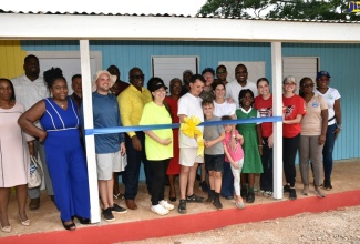 Minister without Portfolio in the Ministry of Economic Growth and Job Creation with Responsibility for Works, Hon. Robert Morgan (right, second row), joins representatives of Food For the Poor, Kind Heart Foundation, teachers, staff students of Brixton Hill Primary and Infant School in Clarendon, at the official handover of the institution’s newly constructed Infant Department building on Sunday (June 9). Mr. Morgan is Member of Parliament for Clarendon North Central, where the school is located. The building’s construction was spearheaded by Food For the Poor.

