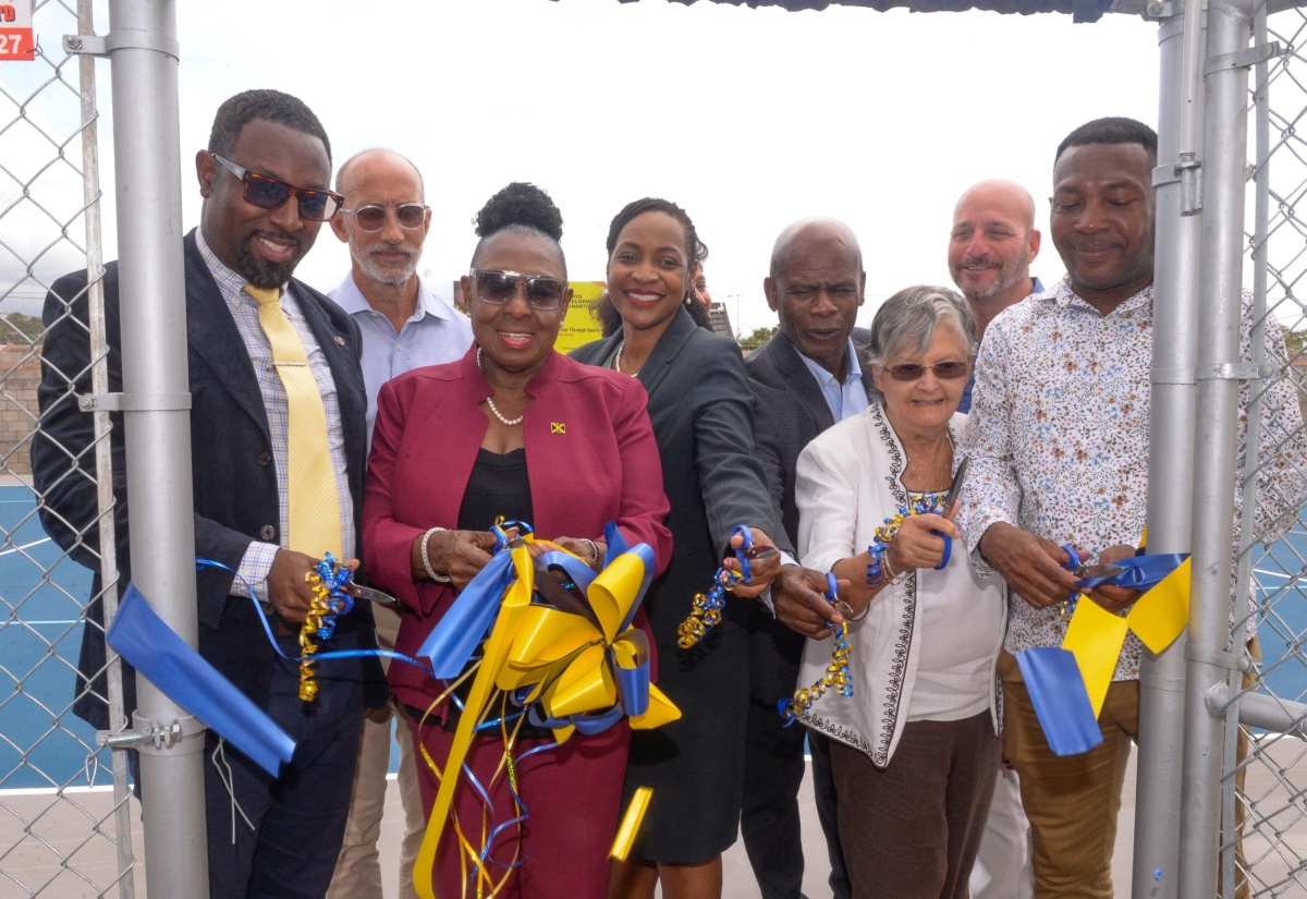 Minister of Culture, Gender, Entertainment and Sport, Hon. Olivia Grange (third left), and Minister of State in the Ministry of Education and Youth, Hon. Marsha Smith (fourth left), lead in the ribbon-cutting at the multipurpose court at the tuition-free Christel House, at Twickenham Park, St. Catherine, today (June 4). Others pictured (from left) are Executive Principal of the school, Jason Scott; General Manager of the Sport Development Foundation of Jamaica, Alan Beckford;  Custos of Kingston and Chairman of the school, Hon. Steadman Fuller; National Ambassador for Christel House Jamaica, Sally Porteous; and Councillor for the Westchester Division, Renair Benjamin, who represented Mayor of Spanish Town, Councillor Norman Scott.


