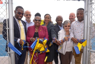 Minister of Culture, Gender, Entertainment and Sport, Hon. Olivia Grange (third left), and Minister of State in the Ministry of Education and Youth, Hon. Marsha Smith (fourth left), lead in the ribbon-cutting at the multipurpose court at the tuition-free Christel House, at Twickenham Park, St. Catherine, today (June 4). Others pictured (from left) are Executive Principal of the school, Jason Scott; General Manager of the Sport Development Foundation of Jamaica, Alan Beckford;  Custos of Kingston and Chairman of the school, Hon. Steadman Fuller; National Ambassador for Christel House Jamaica, Sally Porteous; and Councillor for the Westchester Division, Renair Benjamin, who represented Mayor of Spanish Town, Councillor Norman Scott.

