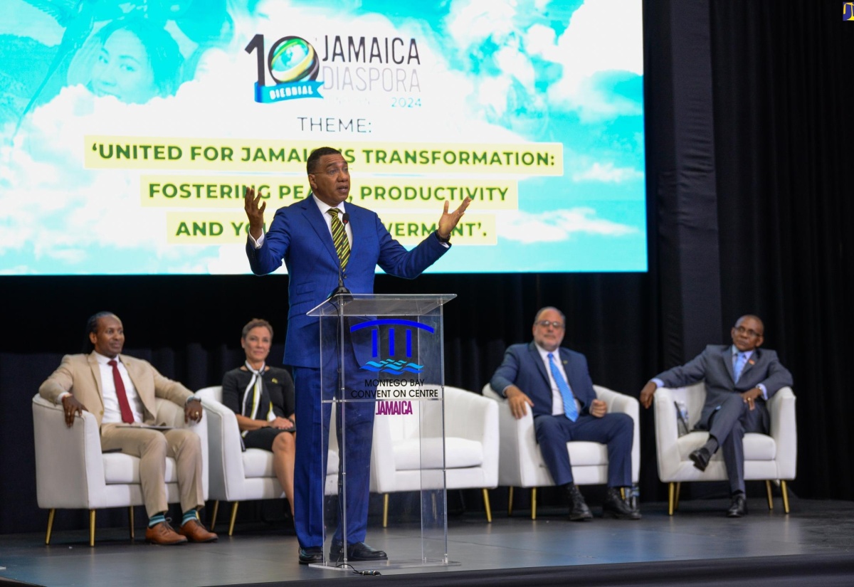 Prime Minister, the Most Hon. Andrew Holness (at lectern), emphasises a point during the opening ceremony for the 10th Biennial Jamaica Diaspora Conference at the Montego Bay Convention Centre in St. James on Tuesday (June 18). Listening are (from left) Minister of State in the Ministry of Foreign Affairs and Foreign Trade, Hon. Alando Terrelonge; Minister of Foreign Affairs and Foreign Trade, Senator the Hon. Kamina Johnson Smith; Leader of the Opposition, Mark Golding; and President and Chief Executive Officer, VM Group and Diaspora Conference Chair,  Courtney Campbell.


