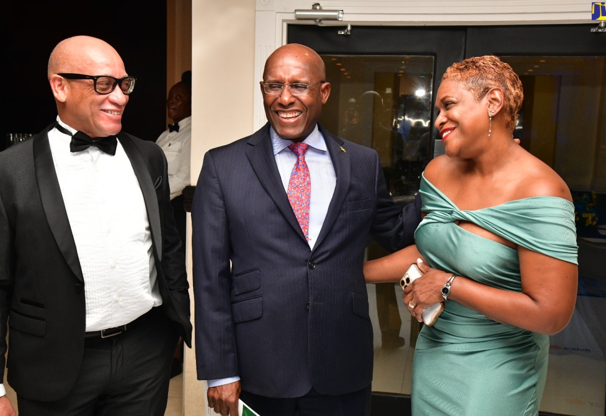 Minister of Industry, Investment and Commerce, Senator the Hon. Aubyn Hill (centre) shares a light moment with incoming President of the Rotary Club of Kingston, Sixto Coy (left) and his wife, Chief Executive Officer, GK Foods International Business, Andrea Coy. Occasion was the Rotary Club of Kingston’s Forensic Installation Ceremony and Banquet on June 27 at The Jamaica Pegasus hotel in Kingston.