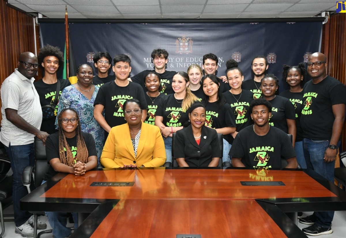 Minister of State in the Ministry of Education and Youth, Hon. Marsha Smith (seated second right) and Acting Chief Education Officer, Ministry of Education and Youth, Terry-Ann Thomas-Gayle (seated second left) share a photo opportunity with members of a delegation from Boston College in Montserrat during their visit to the Ministry’s Heroes Circle offices in Kington on June 3.
