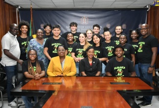 Minister of State in the Ministry of Education and Youth, Hon. Marsha Smith (seated second right) and Acting Chief Education Officer, Ministry of Education and Youth, Terry-Ann Thomas-Gayle (seated second left) share a photo opportunity with members of a delegation from Boston College in Montserrat during their visit to the Ministry’s Heroes Circle offices in Kington on June 3.