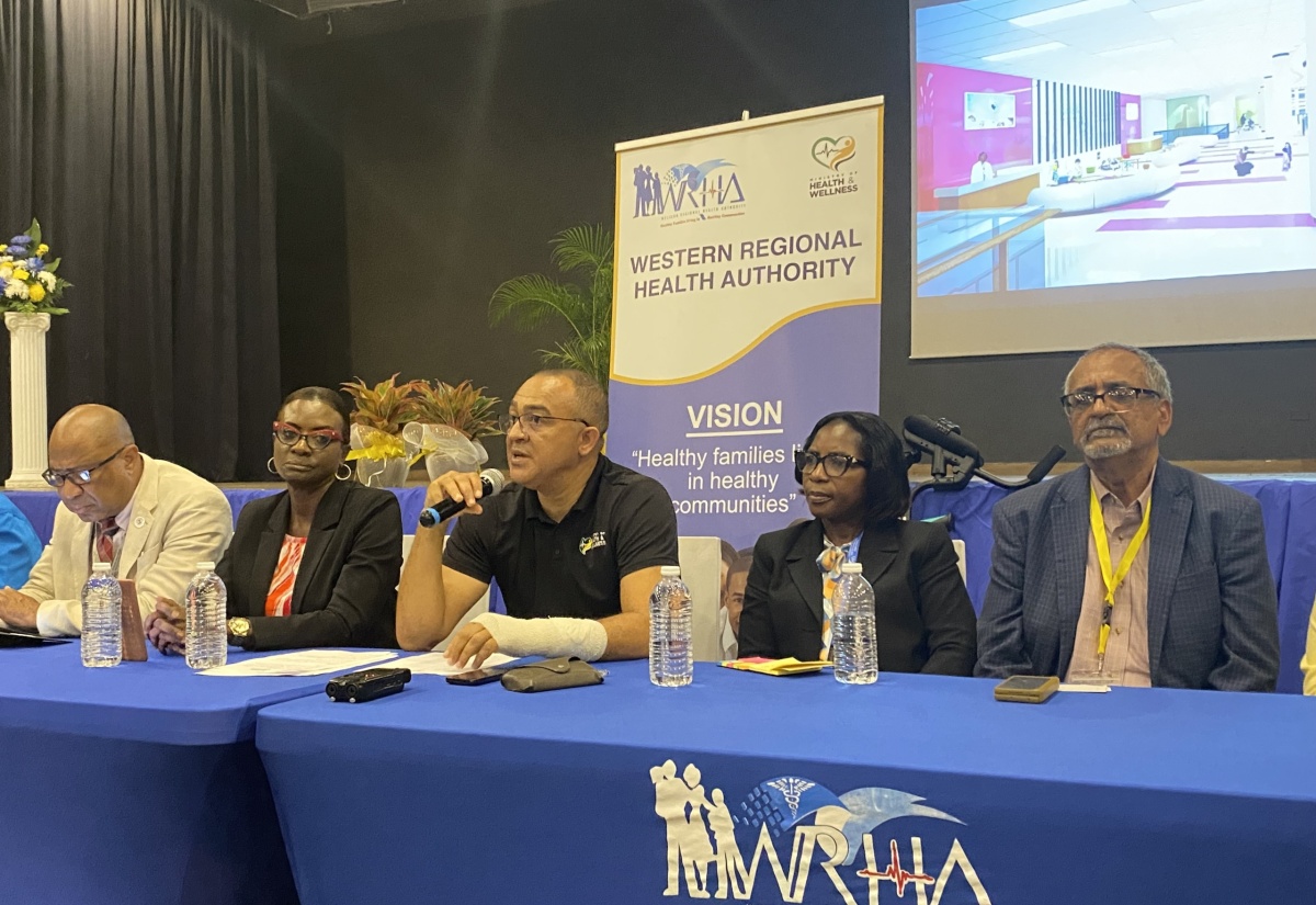 Minister of Health and Wellness, Dr. the Hon. Christopher Tufton (centre), gives an update on the construction of the Western Children and Adolescent Hospital (WCAH), during a press briefing at the Royalton Negril Hotel on Tuesday (June 25). He is joined at the head table by (from left) Regional Director, Western Regional Health Authority (WRHA), St. Andrade Sinclair; Senior Medical Officer, WCAH, Dr. Carleene Grant Davis; Director of Nursing, WCAH, Allison Chambers; and Clinical Coordinator at the Western Regional Health Authority (WRHA), Dr. Delroy Fray.

