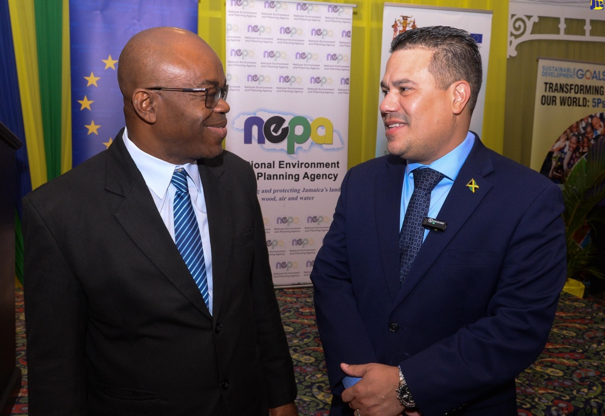 Minister without Portfolio in the Ministry of Economic Growth and Job Creation, Senator the Hon. Matthew Samuda (right), converses with Chief Executive Officer, National Environment and Planning Agency (NEPA), Leonard Francis, during Wednesday’s (June 5) symposium on ecosystems restoration, in observance of World Environment Day, at The Summit in New Kingston.

