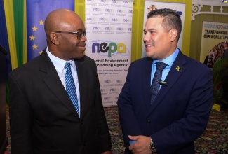 Minister without Portfolio in the Ministry of Economic Growth and Job Creation, Senator the Hon. Matthew Samuda (right), converses with Chief Executive Officer, National Environment and Planning Agency (NEPA), Leonard Francis, during Wednesday’s (June 5) symposium on ecosystems restoration, in observance of World Environment Day, at The Summit in New Kingston.

