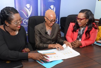 Minister of Education and Youth, Hon. Fayval Williams (centre), conversess with Permanent Secretary in the Ministry, Dr. Kasan Troupe (right), and Acting Chief Education Officer, Terry Ann Thomas Gayle, as they view the 2024 Primary Exit Profile (PEP) results during a press conference on Friday (June 21) at the Ministry’s offices in Kingston.
