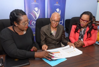 Minister of Education and Youth, Hon. Fayval Williams (centre), peruses the 2024 Primary Exit Profile (PEP) results with Acting Chief Education Officer in the Ministry, Terry Ann Thomas Gayle (left), and Permanent Secretary, Dr. Kasan Troupe, during Friday’s (June 21) press conference at the Ministry’s offices in Kingston.
