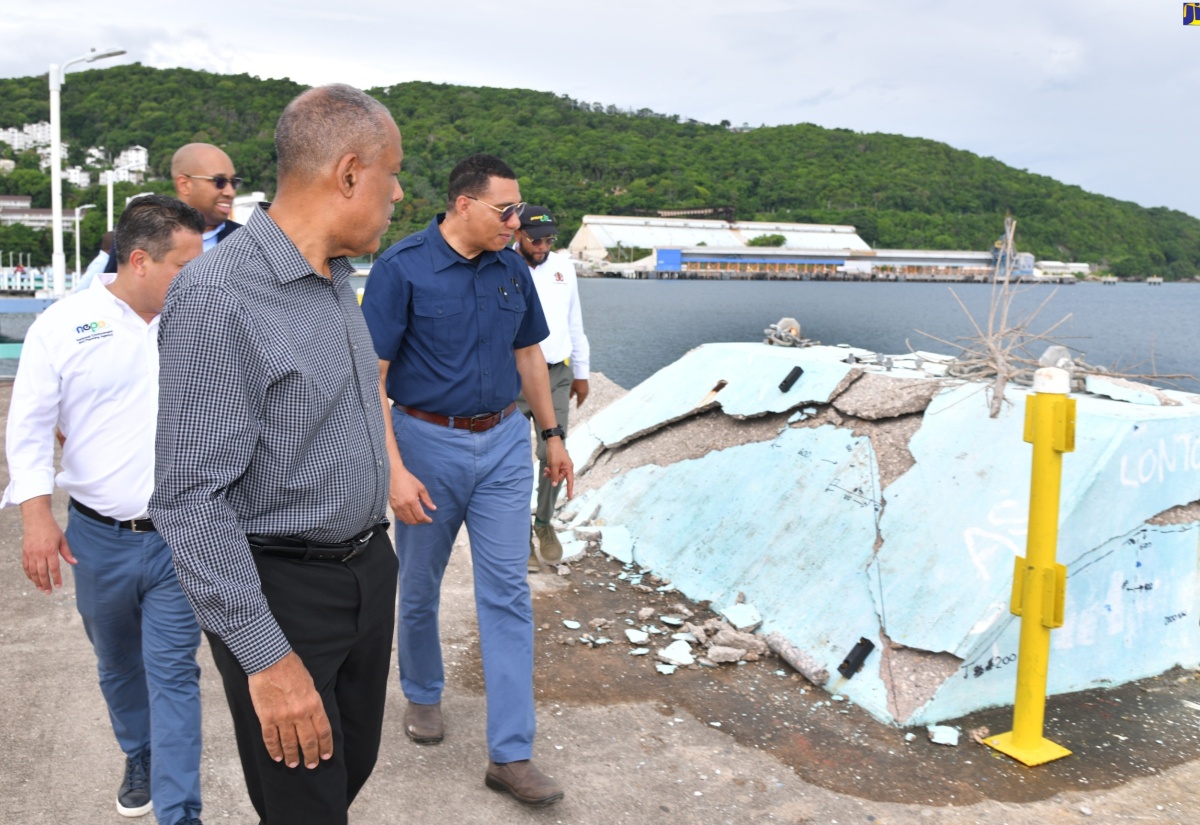 Prime Minister the Most Hon. Andrew Holness (right), examines the damage done at the Ocho Rios Pier in St. Ann, during a tour of the facility on Friday (June 21) with Chief Executive Officer of the Port Authority of Jamaica (PAJ), Professor Gordon Shirley (left). Others present from (background, left) are Minister without Portfolio in the Ministry of Economic Growth and Job Creation, Senator the Hon. Matthew Samuda; Senior Strategist and Advisor in the Ministry of Tourism, Delano Seiveright and Mayor of St Ann’s Bay, Councillor Michael Belnavis.
