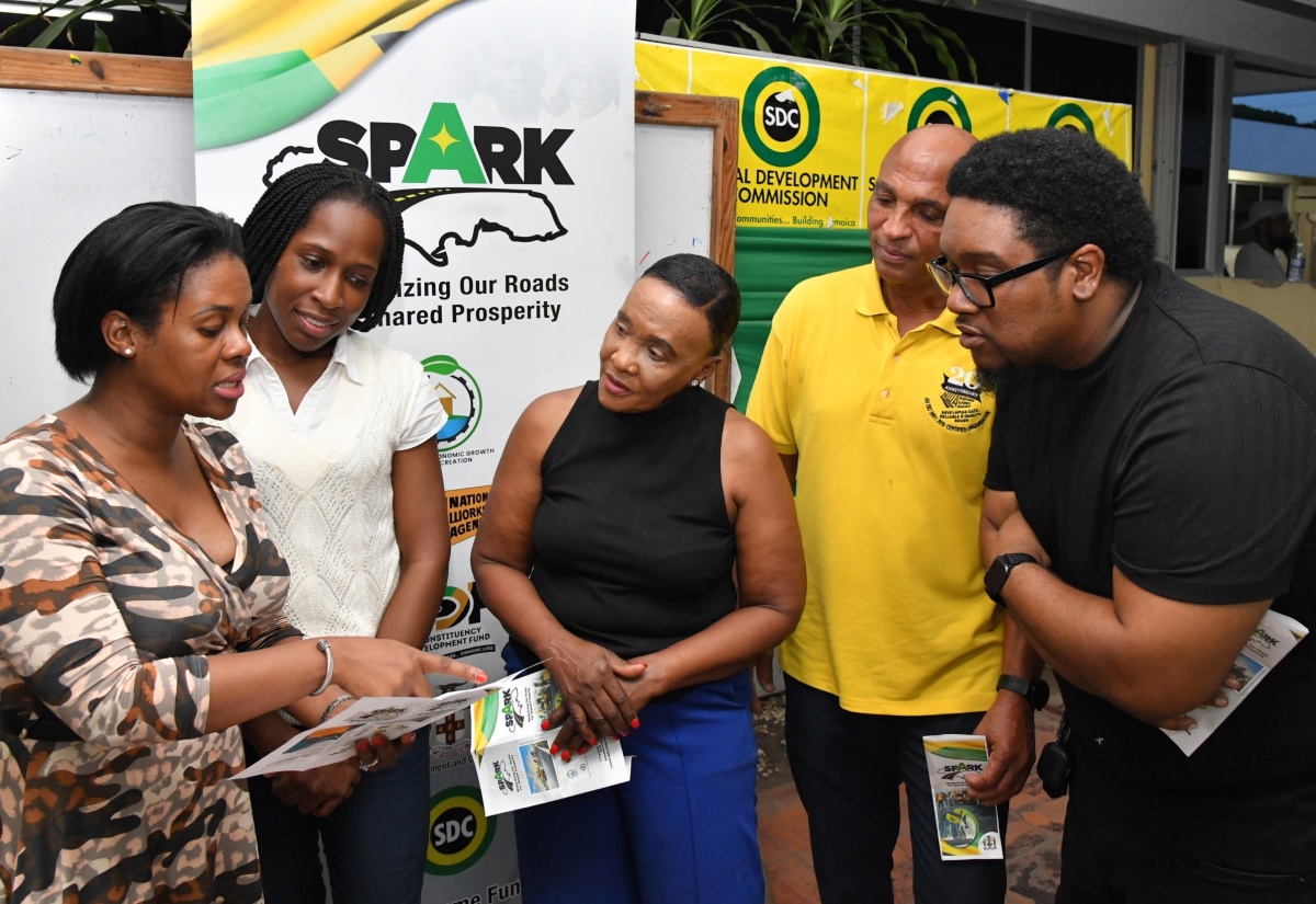 Director, Constituency Development Fund (CDF), Kedesha Rochester (left) explains the Shared Prosperity through Accelerated Improvement to Our Road Network (SPARK) Programme to (from second left) Keystone Community Development Committee member, Kourtnie Dixon; Member of Parliament for St. Catherine Eastern, Denise Daley; Director, Major Projects, National Works Agency (NWA), Richard McHargh; and Parish Manager, Social Development Commission (SDC) St. Catherine, Samuel Heron, during a SPARK Programme consultation meeting held at the SDC St. Catherine Parish Office on May 31.