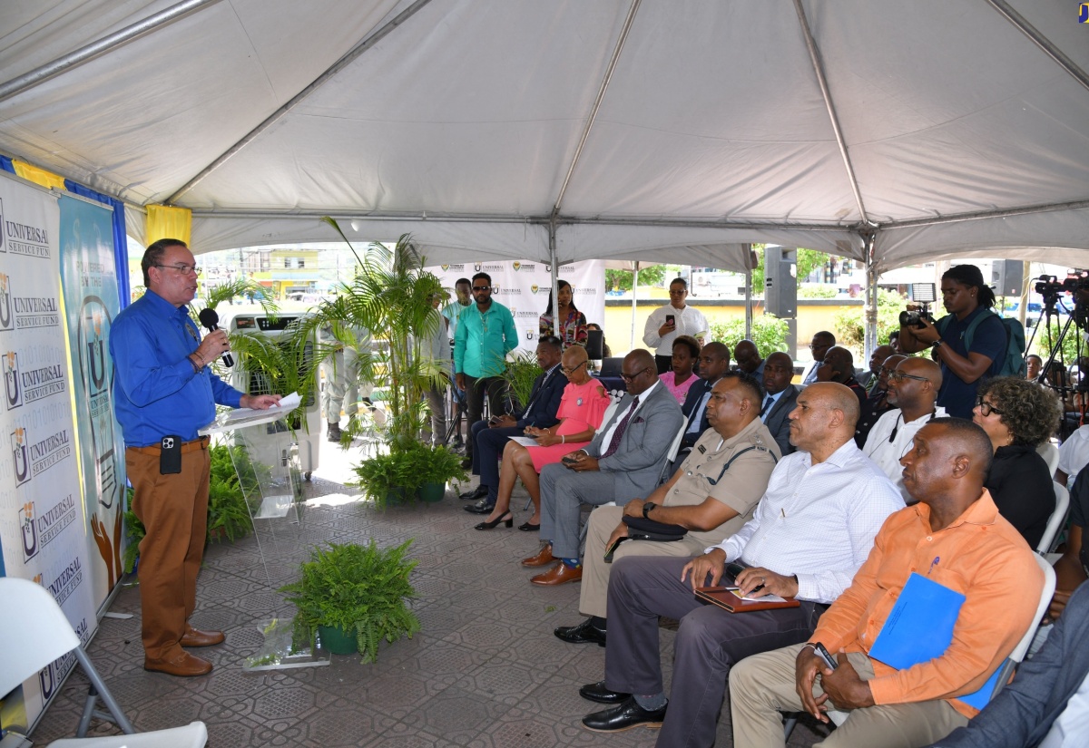Minister of Science, Energy, Telecommunications and Transport, Hon. Daryl Vaz, delivers the keynote address at the launch of a public Wi-Fi hotspot at University Square in Papine, St. Andrew, on Wednesday (June 26) by the Universal Service Fund (USF). Listening are Minister of Education and Youth, Hon. Fayval Williams (second left, seated) and Mayor of Kingston, Councillor Andrew Swaby (left, seated).

