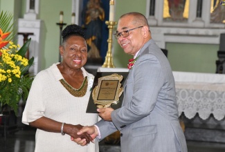 Minister of Culture, Gender, Entertainment and Sport, Hon. Olivia Grange (left) receives a plaque from Vice Chairman, Institute of Jamaica (IOJ) Council, Orville Hill, at the IOJ’s 145th Anniversary Church Service held at the Kingston Parish Church on Sunday (June 2).