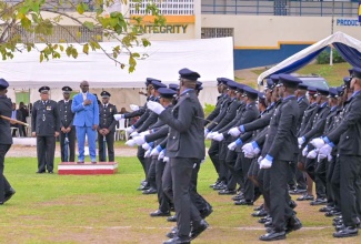 Minister of Local Government and Community Development, Hon. Desmond McKenzie (in blue suit), observes as members of the Jamaica Fire Brigade’s (JFB) Intake Number 26 cohort of recruits execute a march past during their graduation ceremony at the JFB’s temporary training facility, the Madge Saunders Conference Centre in Tower Isle, St. Mary, on Saturday (June 8). Minister McKenzie was the guest speaker. Also looking on are JFB Acting Commissioner, Warren Malcolm (second left), and several senior officers. One hundred recruits, comprising 87 males and 13 females, graduated.