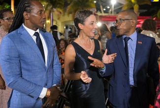 Minister of Foreign Affairs and Foreign Trade, Senator the Hon. Kamina Johnson Smith (centre) and State Minister in the Ministry, Hon. Alando Terrelonge (left), interact with Diaspora Conference Chair, Courtney Campbell, during the Welcome Reception for the 10th Biennial Jamaica Diaspora Conference,  held at the Montego Bay Convention Centre in St. James on June 16.