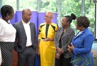 Minister of Education and Youth, Hon. Fayval Williams (centre), converses with (from left) Acting Chief Education Officer, Terry Ann Thomas Gayle; Education Transformation Oversight Committee (ETOC) Chair, Dr. Adrian Stokes; Minister of State in the Ministry, Hon. Marsha Smith and Chief Transformation Officer, Sophia Forbes-Hall.