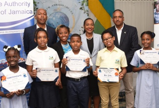 Minister of State in the Ministry of Education and Youth, Hon. Marsha Smith (second right, second row), shares a photo opportunity with participants and members of the Junior Ambassadeurs Programme during Friday’s (June 7) Earth Ambassadeurs World Oceans Day Ceremony at The Jamaica Pegasus hotel in New Kingston. Sharing the moment are (from left, back row) Director General, Maritime Authority of Jamaica (MAJ), Bertrand Smith; Founder, Earth Ambassadeurs, Dr. Andrea Clayton; and Managing Director, Jamaica Social Investment Fund (JSIF), Omar Sweeney.
