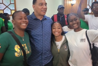 Prime Minister, the Most Hon. Andrew Holness, with a group of young people during a meeting held at the Almond Tree Hotel and Restaurant in Ocho Rios, St. Ann, on June 23.

