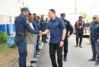 Prime Minister, the Most Hon. Andrew Holness (centre), congratulates members of the Jamaica Constabulary Force attached to the Black River Police Station in St. Elizabeth for their support during Hurricane Beryl’s passage, while touring the parish on Thursday (July 4) to assess damage sustained.

