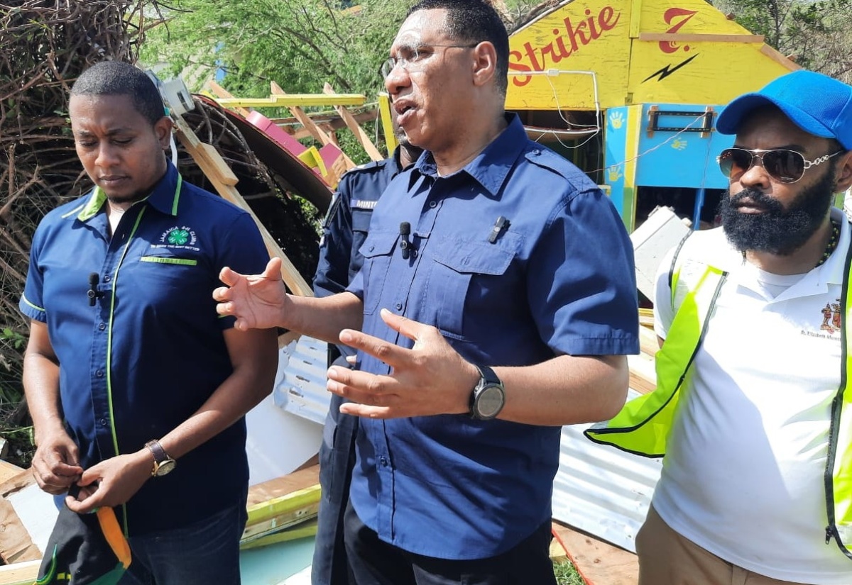 Prime Minister, the Most Hon. Andrew Holness (centre), converses with Minister of Agriculture, Fisheries and Mining, Hon. Floyd Green (left), and Mayor of Black River, Councillor Richard Solomon, during a tour of St. Elizabeth on Thursday (July 4) to assess the impact of Hurricane Beryl on the parish.